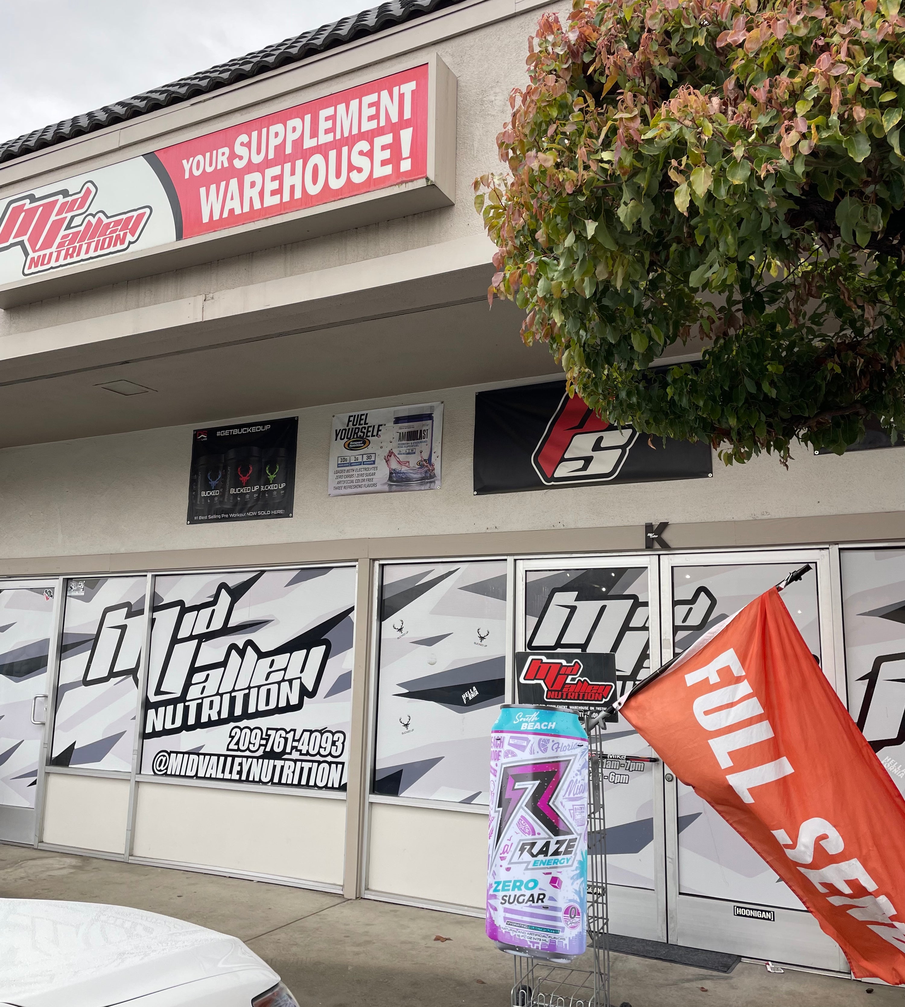 Storefront with 'Mid Valley Nutrition' branding and a supplement bottle in front.